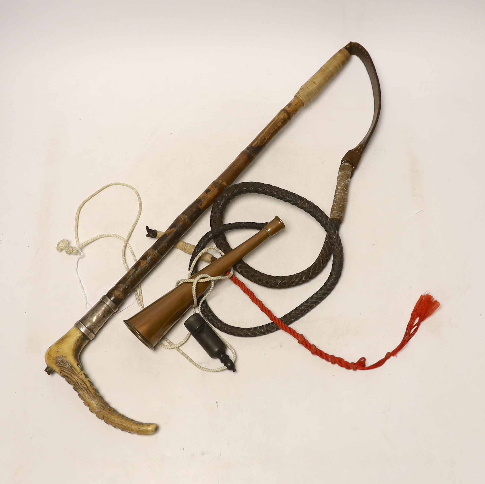 A silver mounted riding crop, a hunting horn and a horn whistle